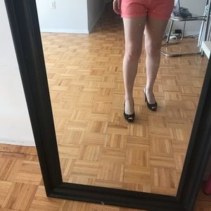 High heel shoes and orange shorts